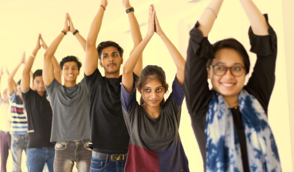 A vibrant group of young adults in a yoga class exuding enthusiasm and concentration.